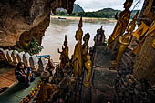 Luang Prabang, Laos - The Pak Ou Caves, the lower cave called Tham Ting. The caves, a Buddhist pilgrimage site, are a repository of old Buddha statues. 